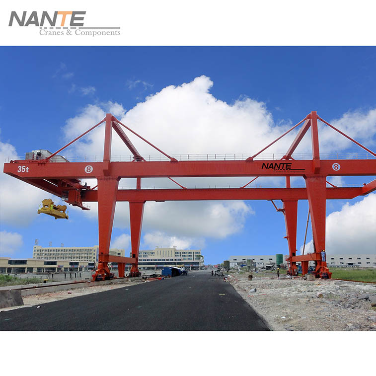 A gantry crane is an overhead lifting device that is designed to lift and move heavy loads. It operates on a set of legs that run along a track, which can be either fixed or mobile.